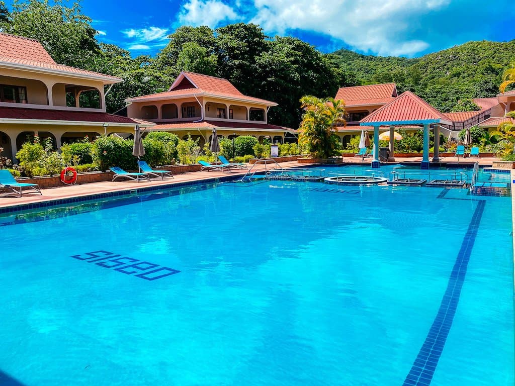 Oasis Hotel swimming pool with the hotel name written on the pool floor, Praslin, Seychelles